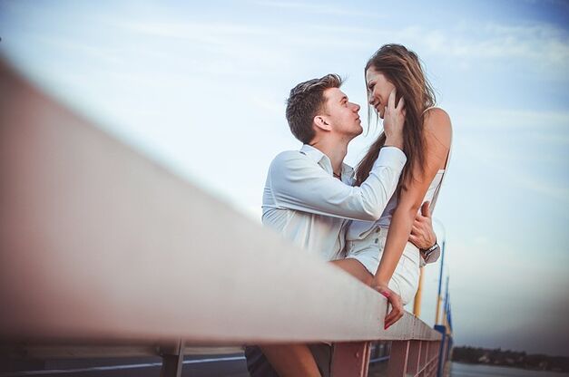 A woman in the arms of a man with excellent power